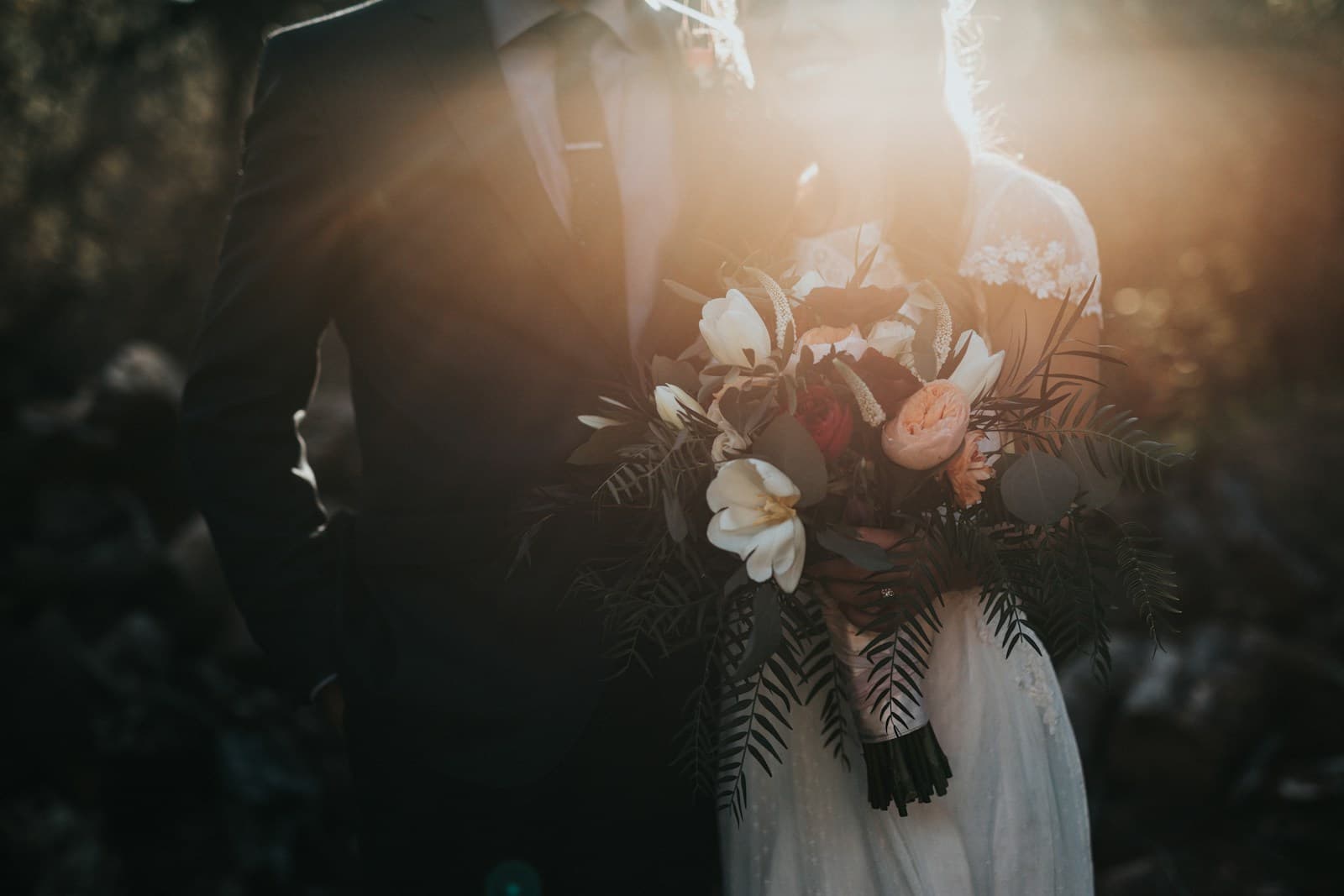 A couple celebrating together beneath warm evening sunlight. Temporary editorial photograph.