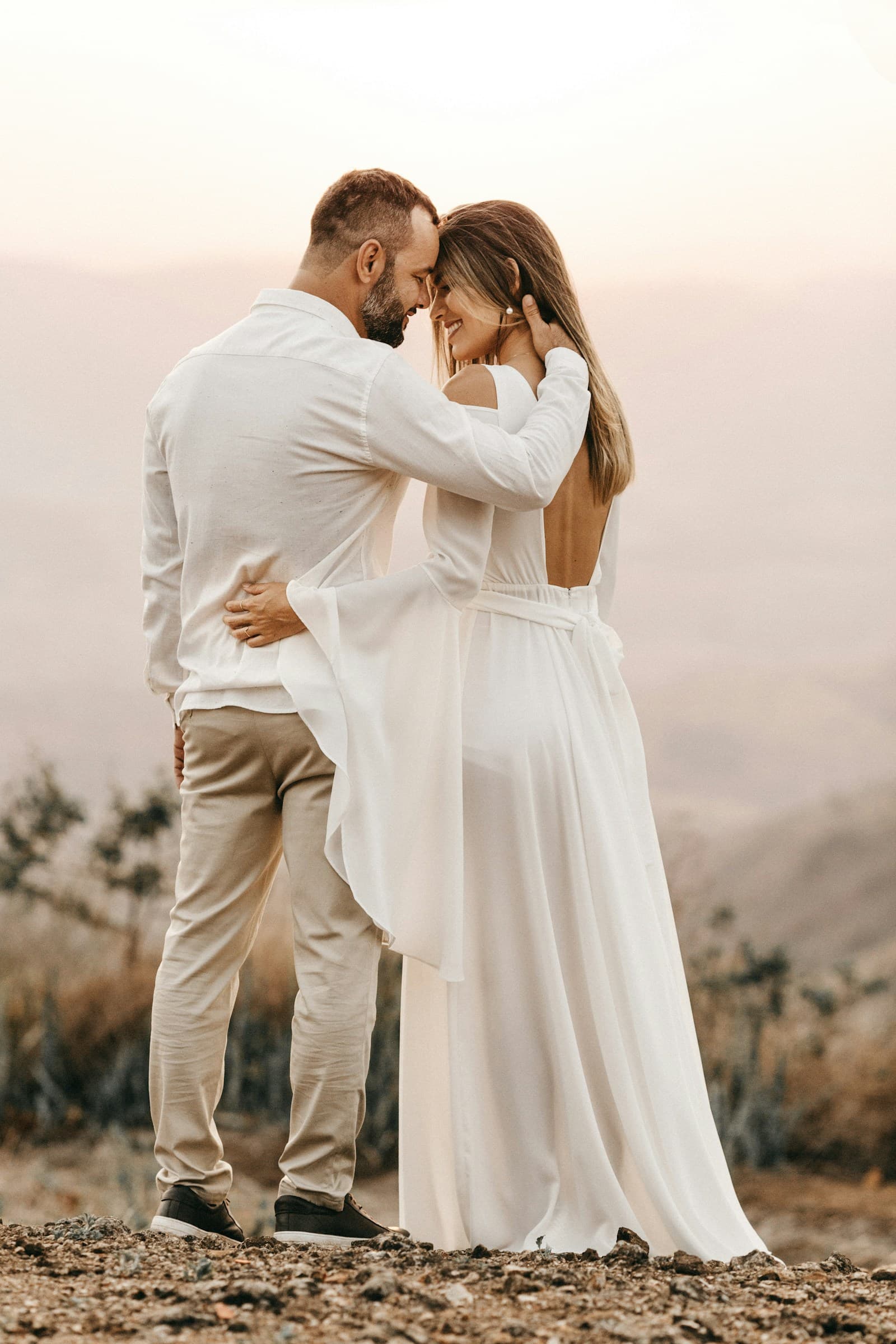 A couple embracing on a sunlit country path. Temporary editorial photograph.